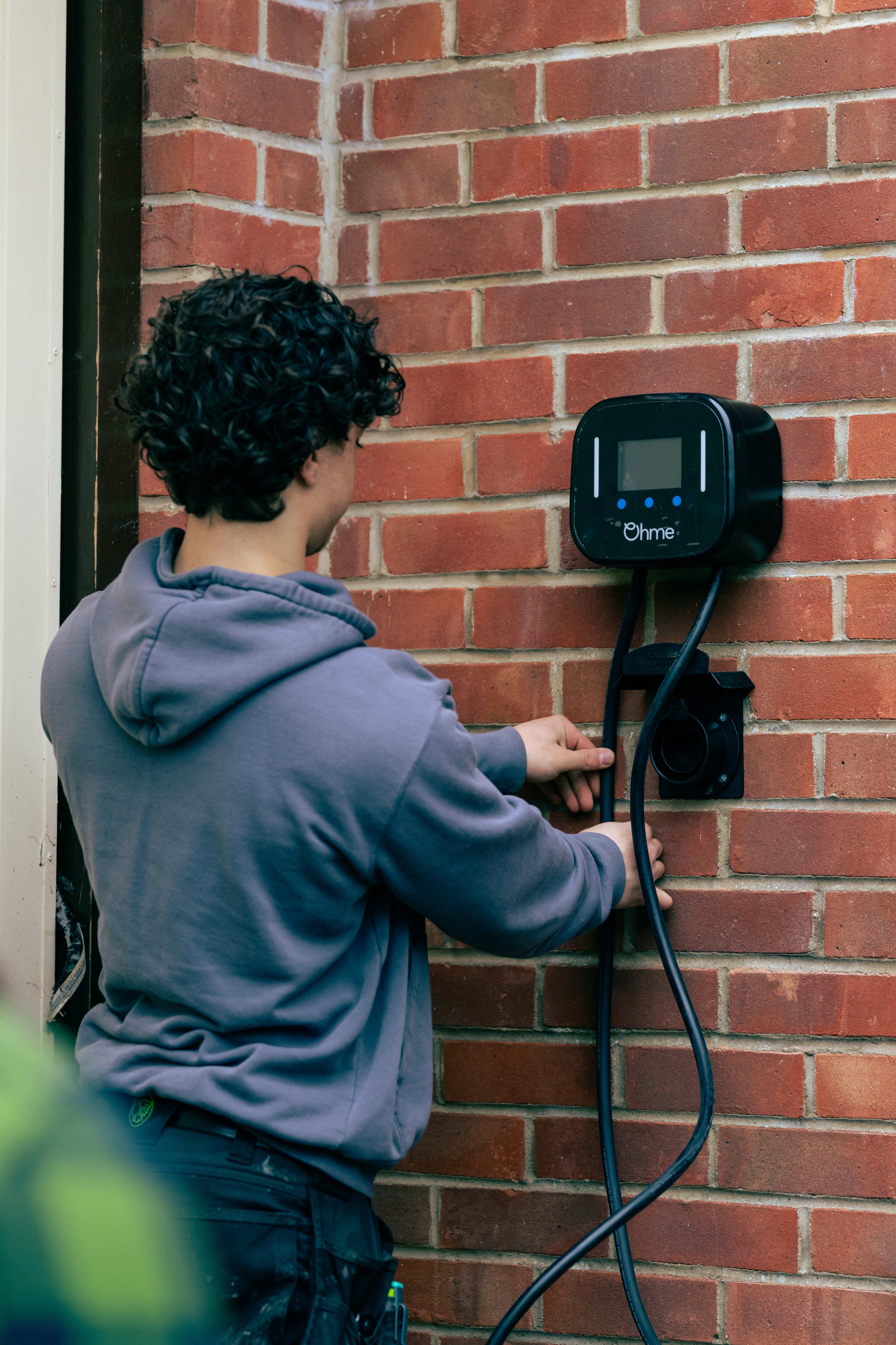 Plug In Stations engineer fitting an Ohme charger
